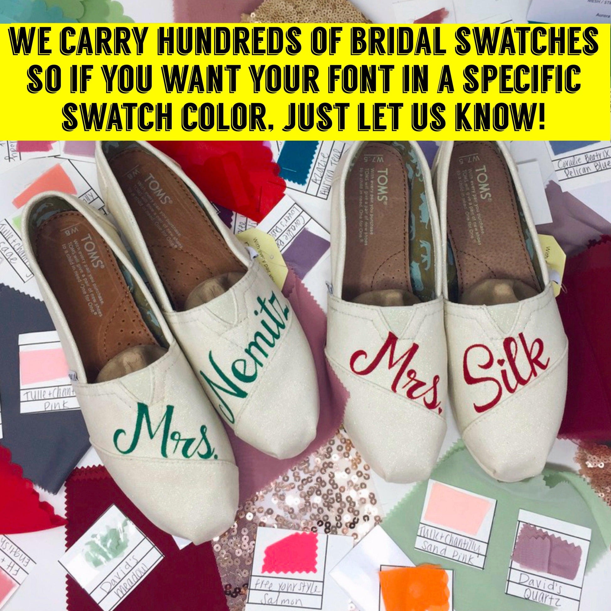 a pair of bridal shoes surrounded by wedding bridal swatches & a sign that says "We can match your wedding shoes with your bridesmaids dress".