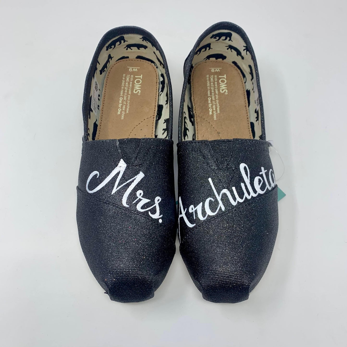 Black Glitter Slip On TOMS shoes with Mrs. painted on front for a bride. white background