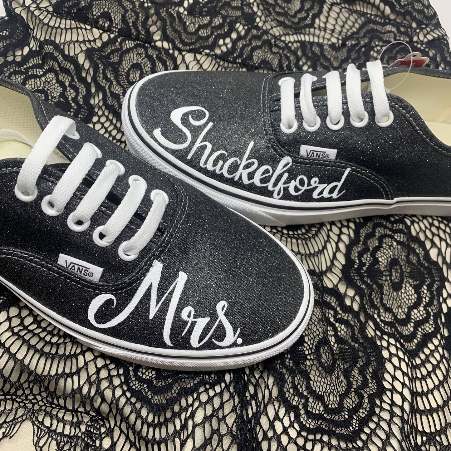 Mrs. Shackelford painted on a pair of Black Glitter Wedding laced Vans, with a black laced cloth underneath the shoes.