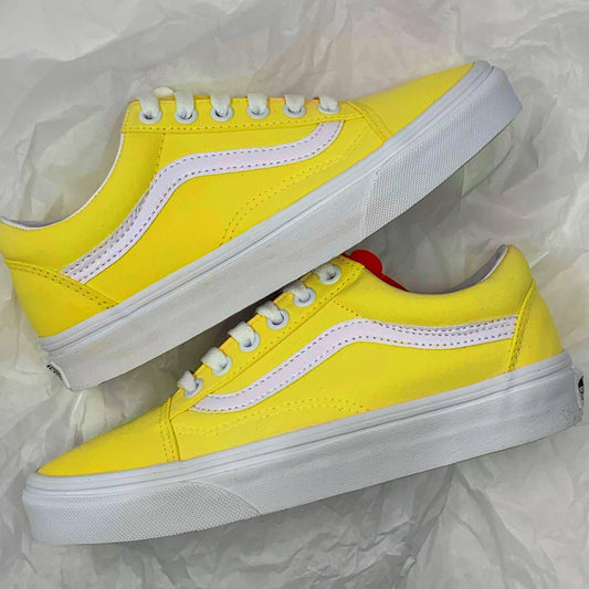 Bright Yellow Old Skool Vans sneakers laying on tissue paper