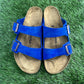 Dyed Royal Blue Arizona Birkenstock sandals on grass.