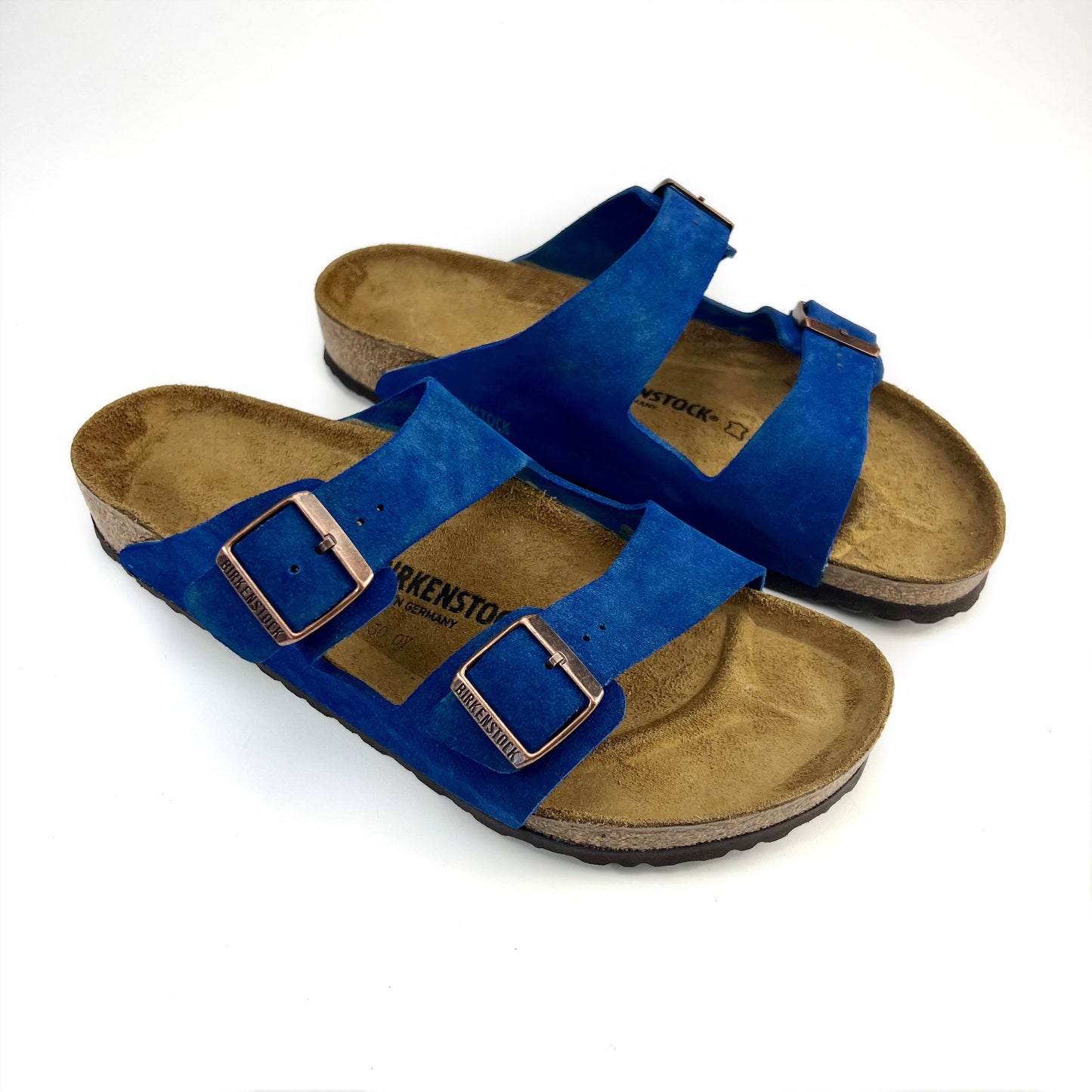 Royal Blue Arizona Birkenstock sandals with bronze buckles & white background