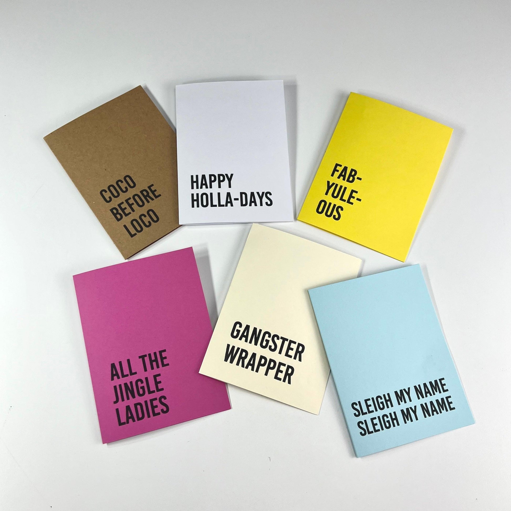 x6 Solid Color Holiday Christmas Cards. Each card is bright color with a bold minimilist font & a funny saying on the front.