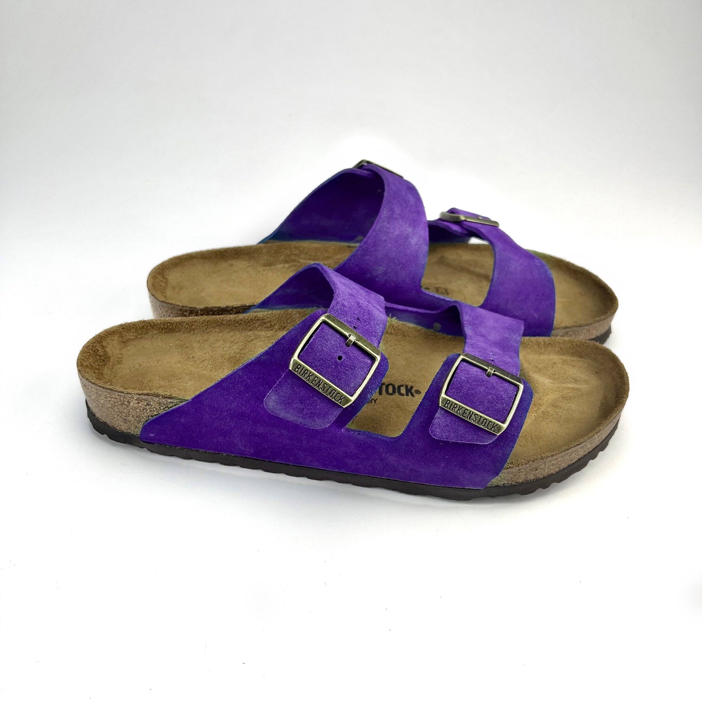 Purple Birkenstock Sandals with copper buckles & white background