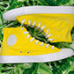 Bright Yellow Hi Top Converse Sneakers on a banana leaf pattern floor