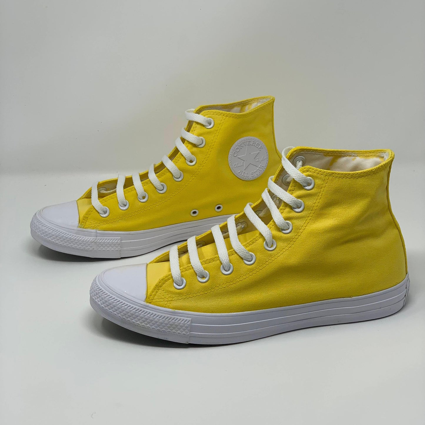 Bright Yellow Laced Hi Top Converse with White background